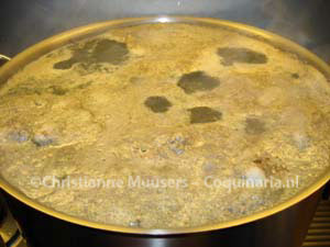 The veal stock is nearly boiling. It need to be skimmed before further preparation