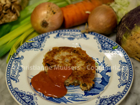 The vegetable cutlet with sauce and the vegetables that were used in the background
